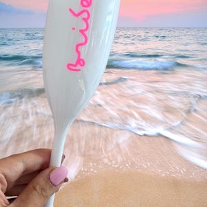 Personalized acrylic champagne flutes with custom Love Island inspired names and colorful vinyl decals. Lightweight reusable 5 oz flutes perfect for bachelorette parties, bridal showers, girls trips, birthdays, and party favors. Customized drinkware with tropical summer aesthetic.