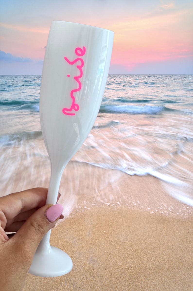 Personalized acrylic champagne flutes with custom Love Island inspired names and colorful vinyl decals. Lightweight reusable 5 oz flutes perfect for bachelorette parties, bridal showers, girls trips, birthdays, and party favors. Customized drinkware with tropical summer aesthetic.