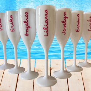 Personalized acrylic champagne flutes with custom Love Island inspired names and colorful vinyl decals. Lightweight reusable 5 oz flutes perfect for bachelorette parties, bridal showers, girls trips, birthdays, and party favors. Customized drinkware with tropical summer aesthetic.