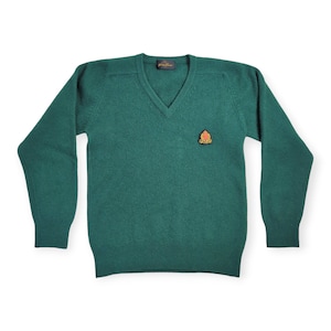 May include: A dark green v-neck sweater with a small embroidered crest on the left chest.