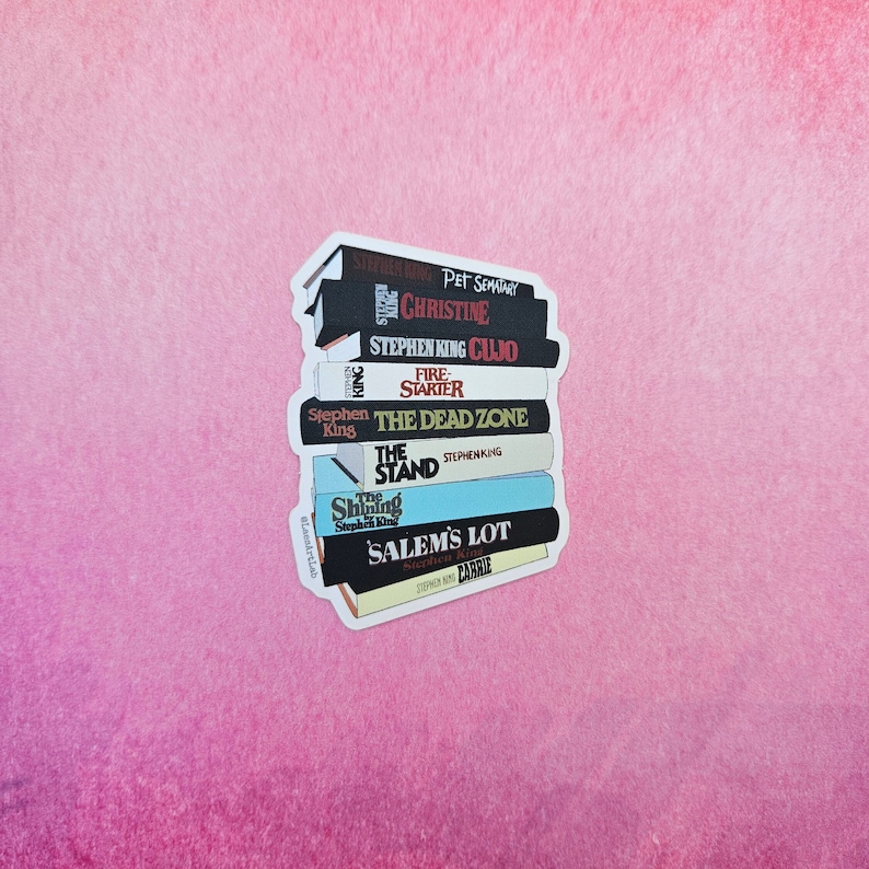 May include: A stack of Stephen King paperback books with titles including "Pet Sematary", "Christine", "Cujo", "Firestarter", "The Dead Zone", "The Stand", "Salem's Lot", and "Carrie".