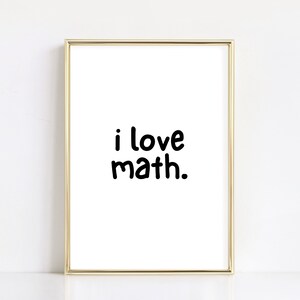 May include: A gold framed print with the text "i love math." in black font.