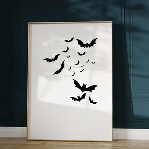 May include: A framed print with a white background and black silhouettes of bats flying in different directions.