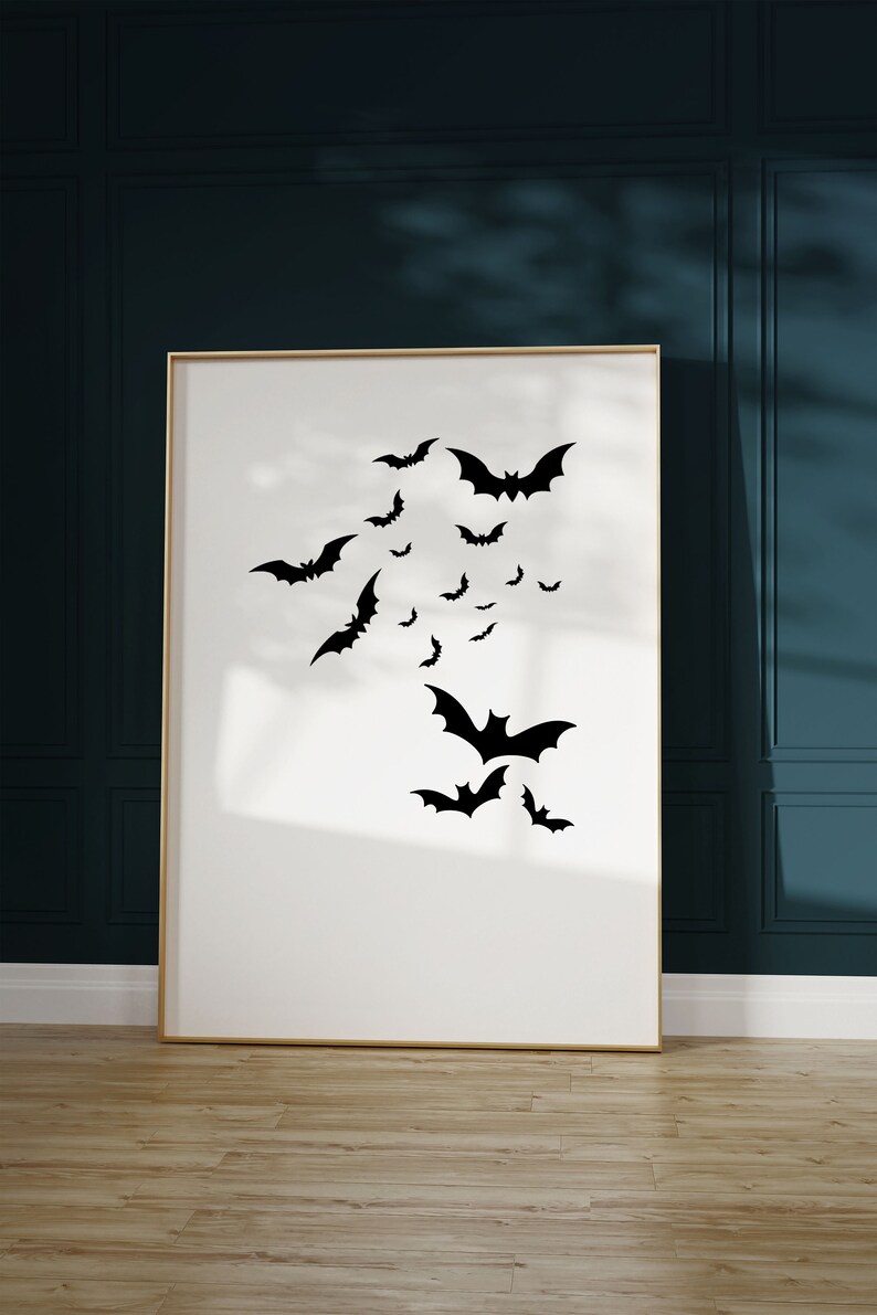 May include: A framed print with a white background and black silhouettes of bats flying in different directions.
