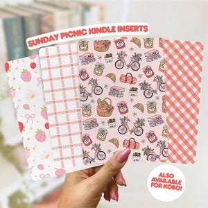 May include: Four rectangular Kindle inserts featuring Sunday Picnic designs. Patterns include pink strawberries, white and pink plaid, a light pink background with bicycles, picnic baskets, jars, and books, and a red and white gingham check pattern.