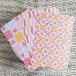 May include: A white ceramic mug with a black handle and the text "But First, Coffee" in a handwritten style. The mug is on a white surface.