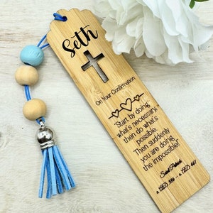 May include: A wooden bookmark with a blue tassel and beads. The bookmark has a cross cut out and the text "Seth On Your Confirmation" and a quote by Saint Patrick.