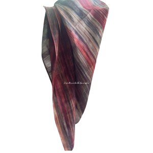 May include: A lightweight silk scarf featuring a vertical abstract pattern in shades of deep red, burgundy, grey, and black. The fabric has a semi-sheer quality with visible folds and the text "Jim Rose Silk Scarfs" printed in white in the centre.