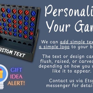 May include: A black vertical grid game board with red and blue circular tokens. The base features the white text CUSTOM TEXT. The image includes the text Personalize Your Game, We can add simple text or a simple logo to your board, and GIFT IDEA ALERT.