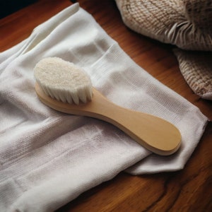 Close-up of a facial dry brush from Kayle at Home, showcasing its bristles and sleek design for a natural skincare routine