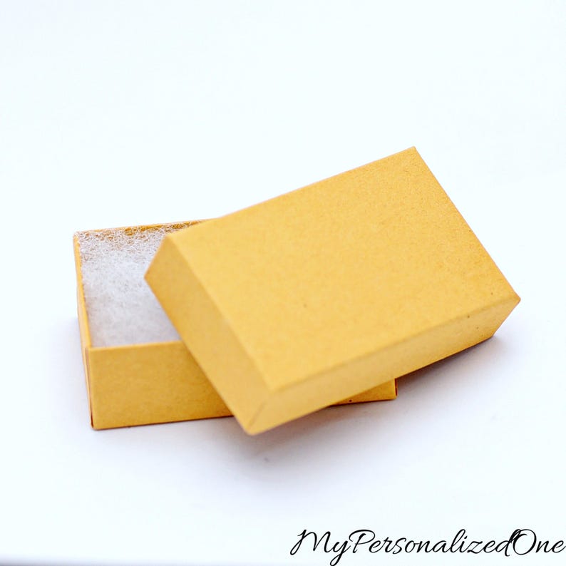 May include: A rectangular, light tan cardboard gift box with a removable lid. The box is partially open, revealing a white, textured foam insert inside. The text "MyPersonalizedOne" is printed in a black, cursive font at the bottom right corner.
