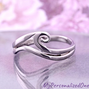 May include: A silver ring with a wave-like design. The ring features a swirling, open-ended spiral at the top, with a smooth, polished finish. The ring's design is minimalist and elegant, suitable for everyday wear.