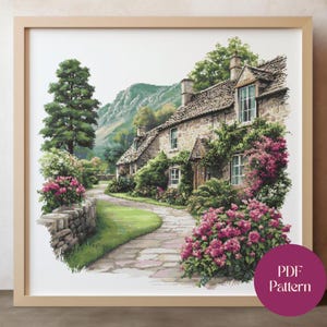 May include: A framed watercolor print of a quaint stone cottage with a winding path. Lush greenery and vibrant pink flowers adorn the building and surrounding landscape. A tall tree and a mountain are in the background. The print is labeled "PDF Pattern".