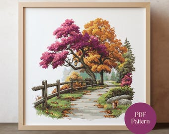 May include: A framed cross-stitch landscape featuring a path winding through a park. The scene includes a wooden fence, trees with vibrant pink and orange foliage, and a small squirrel. The artwork is labeled "PDF Pattern".