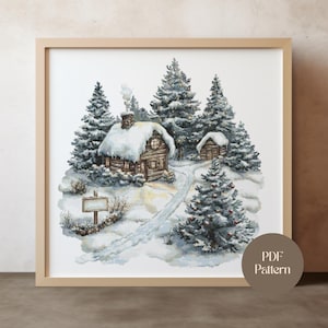 Op de afbeelding: Een ingelijst kruissteekpatroon toont een besneeuwde winterscène. Een gezellige hut met een met sneeuw bedekt dak en een rokende schoorsteen is omgeven door met sneeuw bedekte dennenbomen. Een pad leidt door de sneeuw naar de hut. Een wegwijzer staat op de voorgrond.
