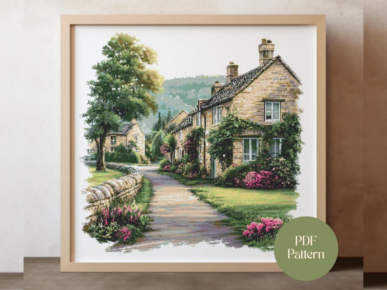 May include: A framed watercolor print of a quaint village scene. The artwork depicts stone houses with climbing plants, a pathway, and vibrant pink flowers. A large tree and a stone wall are on the left. The print is labeled "PDF Pattern".