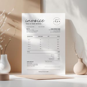 May include: A white invoice with black text, featuring the word "invoice" in a stylish script. The document includes sections for billing, item descriptions, and company details. A logo circle is in the upper right corner.