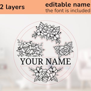 May include: A black and white floral design with the text "YOUR NAME" in a circle. The design is in two layers and the font is included.