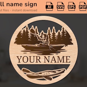 Pode incluir: Um sinal de parede cortado a laser com uma pessoa a fazer caiaque num lago com árvores no fundo. O sinal diz "YOUR NAME" numa fonte decorativa.