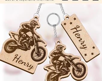 May include: Set of three wooden keychains featuring a motocross rider design. Each keychain has the name "Henry" engraved on it.