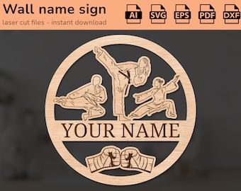 May include: A laser cut wooden sign with a circular design featuring three figures in martial arts poses. The sign includes the text "YOUR NAME" and two fists with bandages.