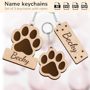May include: Set of three wooden keychains with a paw print design. Each keychain features the name "Becky" engraved on a wooden tag. The keychains are attached to silver key rings.