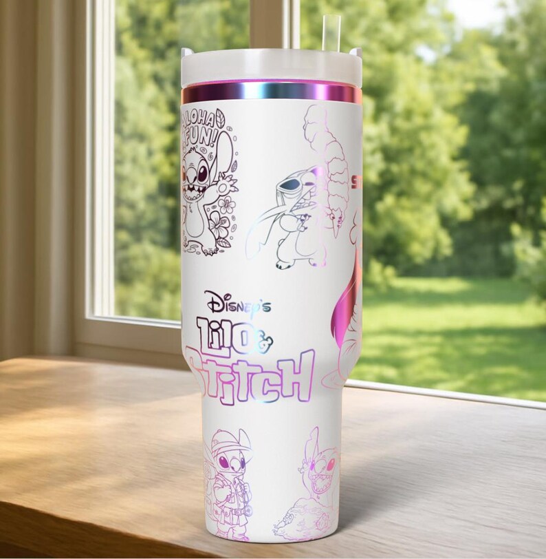 May include: White tumbler featuring multiple illustrations of Stitch from Disney's Lilo & Stitch, with the text "Aloha Fun" and "Disney's Lilo & Stitch". The tumbler has a white lid and a pink and purple iridescent band.