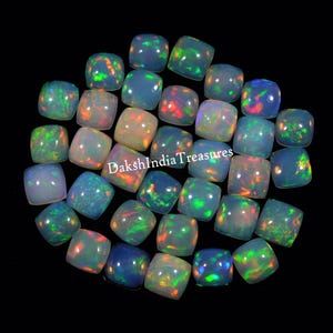 May include: A collection of 30 loose, iridescent, opal cabochons in a cushion shape. The opals are a mix of white, blue, green, and orange.