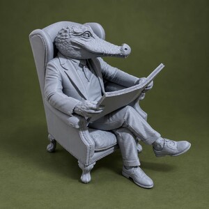 May include: A monochromatic gray figurine of an anthropomorphic alligator wearing a suit and tie, seated in a tufted wingback chair while holding an open newspaper. The figure features detailed scales on the head and hands, with formal shoes.