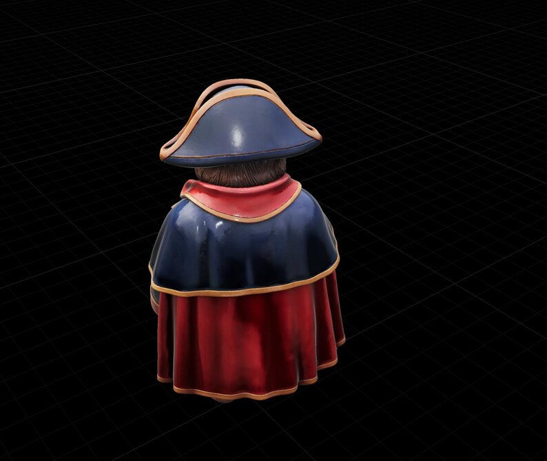 May include: A figurine of a person wearing a tricorn hat, a dark blue cape, and a red robe. The hat has a gold trim. The figurine is viewed from the back, with the head and shoulders visible.
