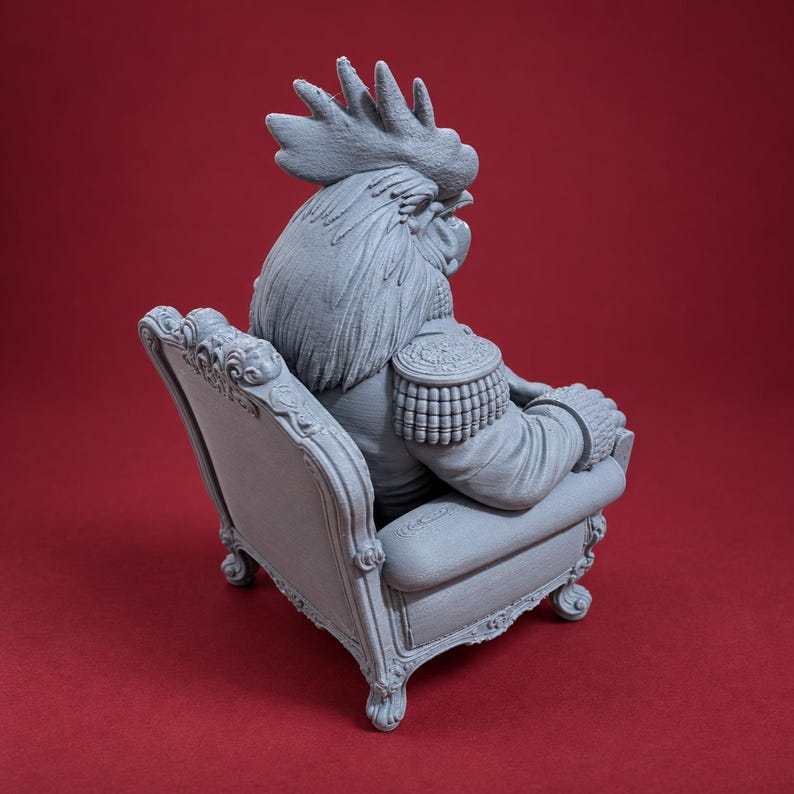 May include: A gray 3D printed figurine of an anthropomorphic rooster wearing a military-style jacket with epaulets, seated in an ornate, carved armchair with scrollwork details on the frame, viewed from a rear three-quarter angle.