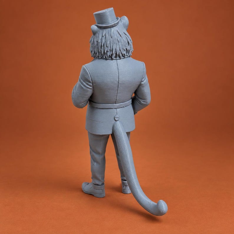 May include: A gray 3D printed figurine of an anthropomorphic cat wearing a formal suit and a top hat. The figure is viewed from the back, showing a long, curved tail extending from the jacket, textured fur on the head, and formal footwear.