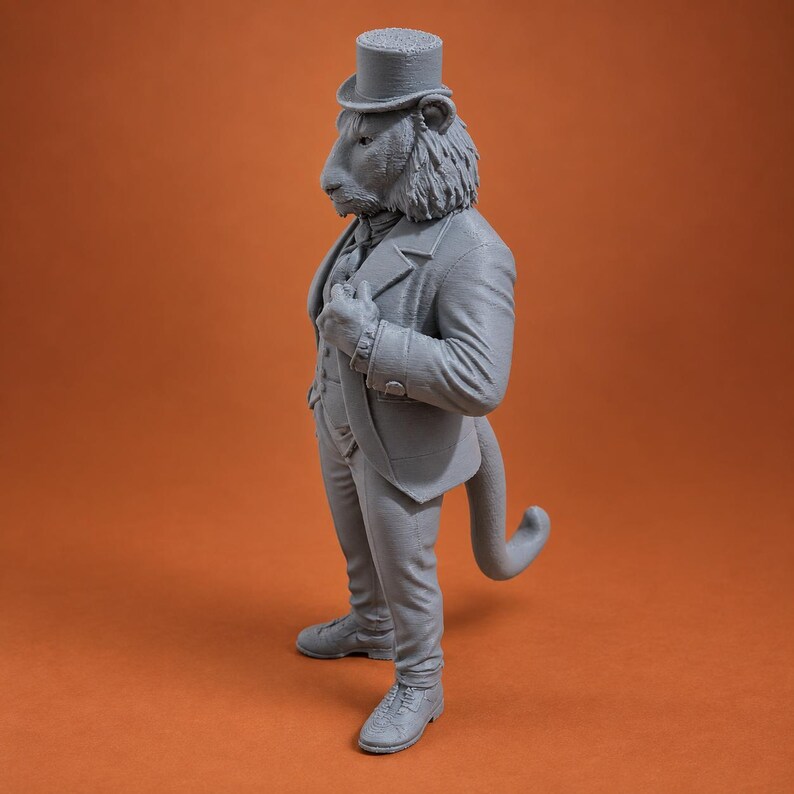 May include: A gray monochromatic figurine of an anthropomorphic lion standing upright. The lion wears a formal suit, a vest, and a top hat. The figure features a textured mane, a long tail, and detailed lace-up shoes, captured in a side profile view.