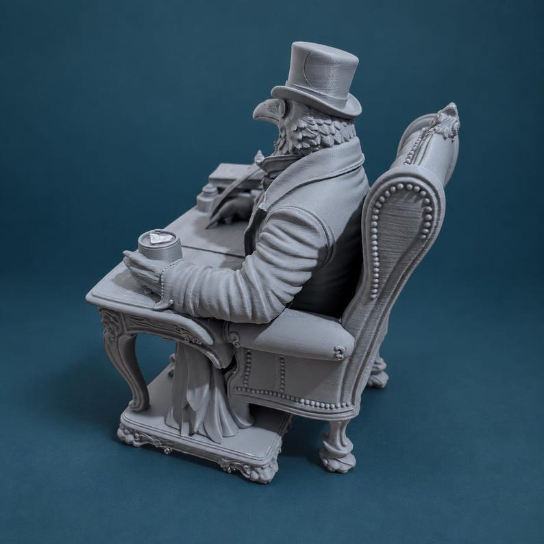 May include: A monochromatic grey 3D printed figurine depicting an anthropomorphic bird character wearing a top hat and formal attire. The figure is seated in a tufted armchair at a desk, holding a quill pen over a small inkwell and paper.