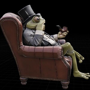 May include: A quirky sculpture of a frog in a suit and top hat, seated in a brown leather armchair. The frog is holding a pipe and appears to be deep in thought. The sculpture has a detailed, realistic appearance.