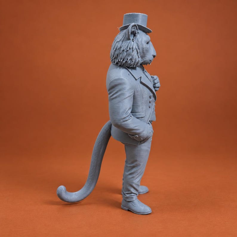 May include: A grey 3D printed figurine of an anthropomorphic lion wearing a formal suit, a waistcoat, and a top hat. The lion is standing in profile, displaying a long, curved tail, textured mane, and detailed clothing folds on the jacket and trousers.