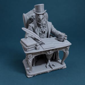 May include: A grey monochromatic figurine of an anthropomorphic bird wearing a top hat, cravat, and formal jacket, seated at an ornate desk. The bird holds a mug, with a quill pen, inkwell, and a stack of books resting on the desk surface.