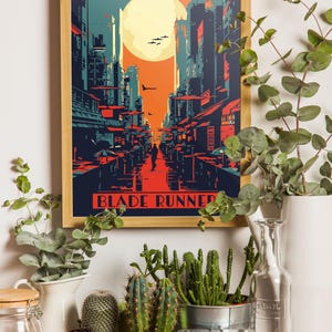 May include: A framed poster with a retro-style illustration of a futuristic cityscape with a large moon in the background. The poster has the text "Blade Runner" at the bottom.