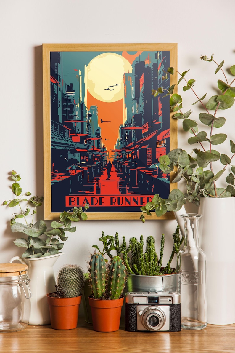 May include: A framed poster with a retro-style illustration of a futuristic cityscape with a large moon in the background. The poster has the text "Blade Runner" at the bottom.