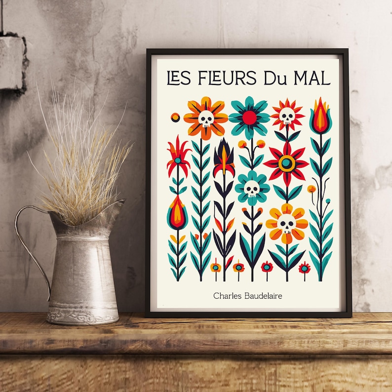 May include: A black framed print with a white background featuring a colorful floral design with skulls. The text "LES FLEURS DU MAL" is at the top of the print and "Charles Baudelaire" is at the bottom.