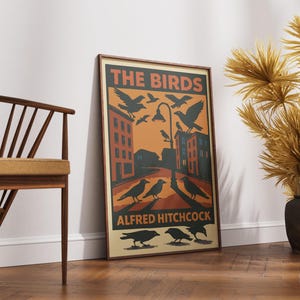 May include: A vintage-style poster for the Alfred Hitchcock film "The Birds". The poster features a black and white illustration of birds flying over a city street with buildings in the background. The text "The Birds" is in a bold, orange font and the text "Alfred Hitchcock" is in a smaller, black font.