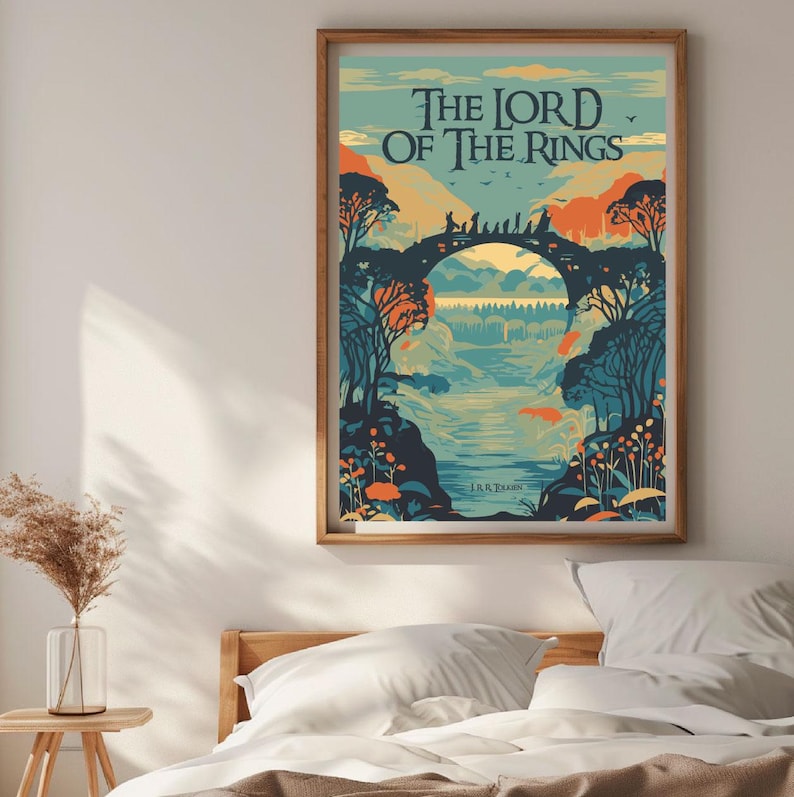 May include: A vintage-style poster for "The Lord of the Rings" by J.R.R. Tolkien. The poster features a colorful illustration of a bridge with figures walking across it, surrounded by trees and a river. The text "The Lord of the Rings" is in a bold, stylized font.