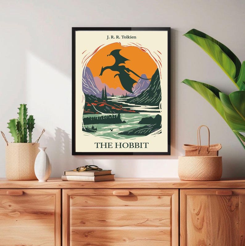 May include: A vintage-style poster for "The Hobbit" by J.R.R. Tolkien. The poster features a black silhouette of a dragon flying over a landscape with mountains, a river, and a sunset.