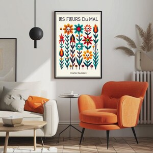 May include: A black framed poster with a white background featuring a colorful illustration of flowers with skulls. The title of the poster is "LES FLEURS DU MAL" by Charles Baudelaire.