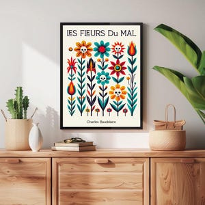 May include: A black framed print with a white background and colorful flowers with skulls. The text "LES FLEURS DU MAL" and "Charles Baudelaire" are printed on the print.