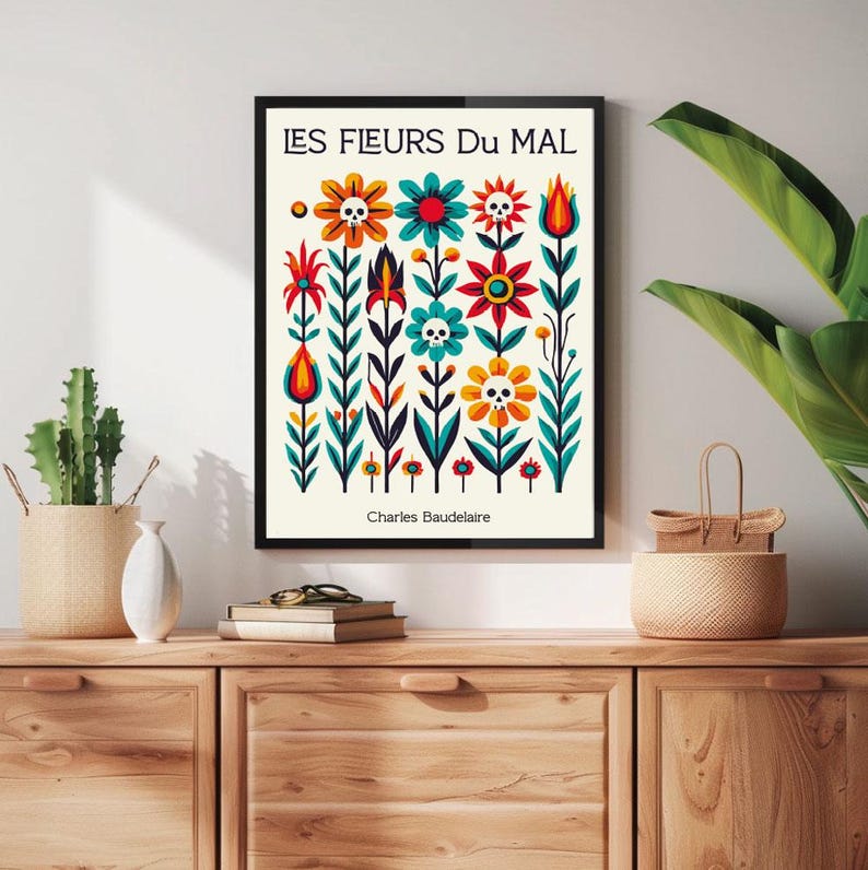 May include: A black framed print with a white background and colorful flowers with skulls. The text "LES FLEURS DU MAL" and "Charles Baudelaire" are printed on the print.