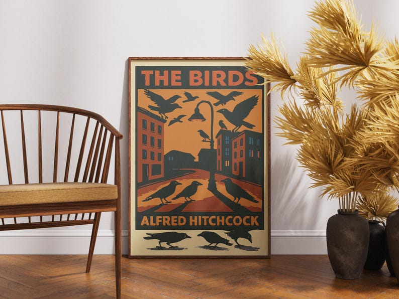 May include: A vintage-style poster with a red, orange, and black color scheme. The poster features the text "THE BIRDS" and "ALFRED HITCHCOCK" with an illustration of a city street and birds flying overhead.