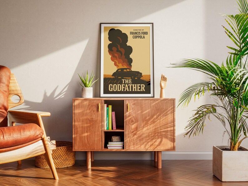May include: A vintage-style poster for the movie "The Godfather" directed by Francis Ford Coppola. The poster features a black and white image of a car engulfed in flames against a yellow background.