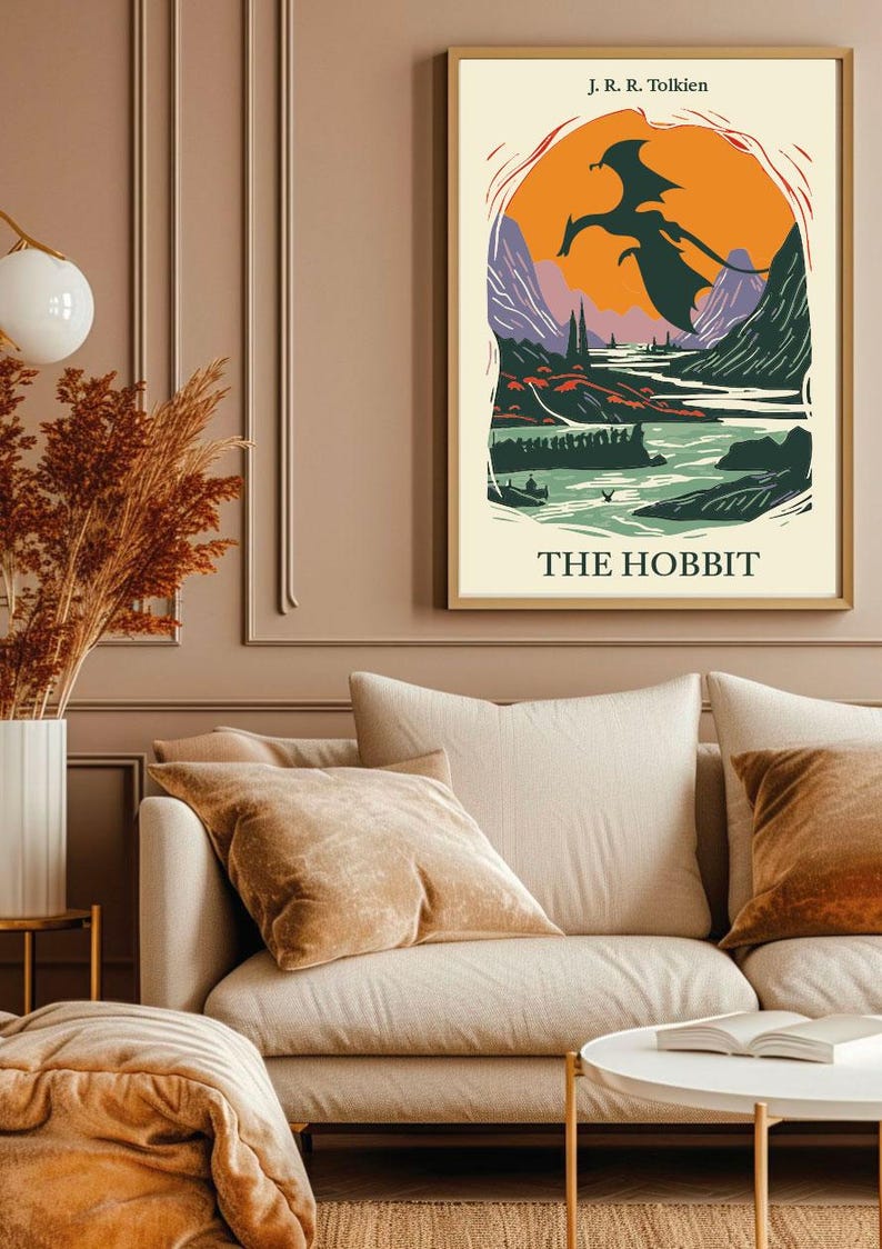 May include: A vintage-style poster for the book "The Hobbit" by J.R.R. Tolkien. The poster features a green, orange, and purple landscape with a black dragon flying over a river. The text "THE HOBBIT" is printed in black at the bottom of the poster.
