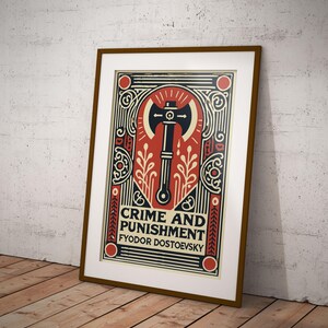 Op de afbeelding: Een ingelijste poster met een rood, wit en zwart kleurenschema. De poster toont een gestileerde illustratie van een bijl met een schedel op de steel. De tekst "CRIME AND PUNISHMENT" en "FYODOR DOSTOEVSKY" is in zwart op de poster gedrukt.